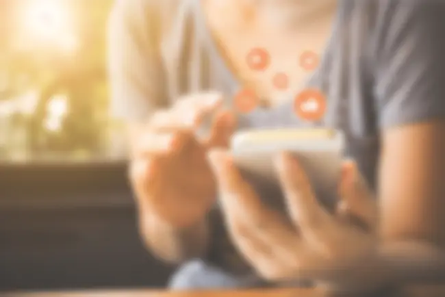 A person with a phone using social media